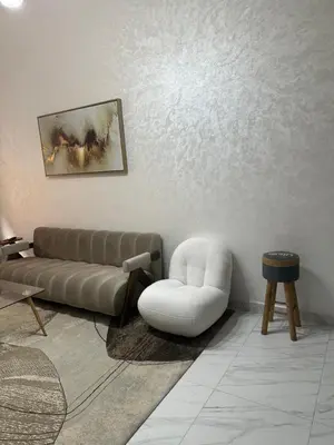 a living room with a couch and a chair at La Citrine appartement de haut standing in Marrakech