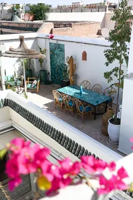 a view of a patio with a table and flowers at Riad Bacha Beldi in Marrakech