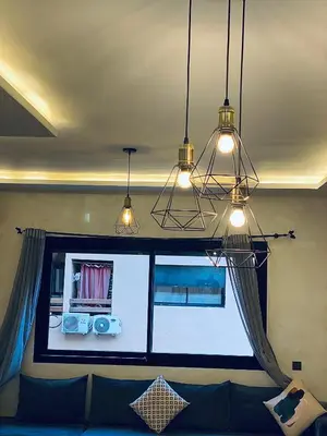 a living room with two lights and a window at Appart26 Marrakech guéliz en face la Gare in Marrakech