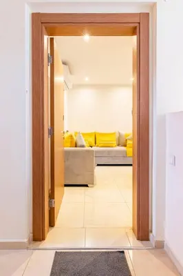 a door leading into a living room with a couch at Wonderful apartment with garden and large pool in Marrakech