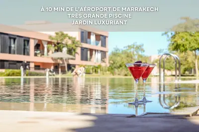 a martini glass sitting in the water next to a fountain at Mya cosy - Clim, Wifi, Jardin à 10min de l'Aéroport in Marrakech