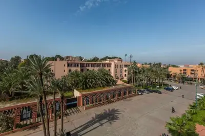 a view of a street with palm trees and buildings at Modern apartment centre ville in Marrakech