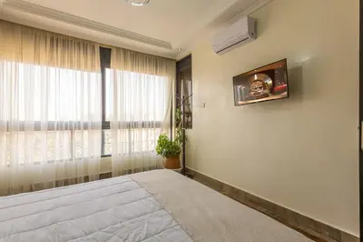 a bedroom with a large bed and a window at Elegant apartment downtown in Marrakech