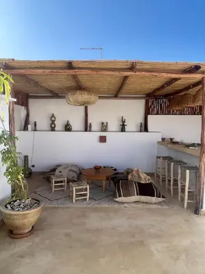 a room with a table and chairs in a building at Riad Dar Victoire in Marrakech