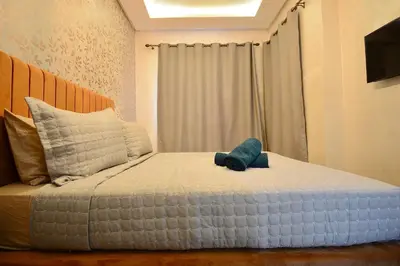 a bed with a stuffed animal on top of it at Serenity City Center Apt in Marrakech