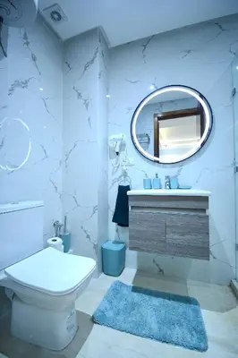 a bathroom with a toilet sink and a mirror at Serenity City Center Apt in Marrakech
