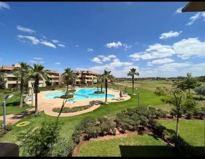 an image of a swimming pool in a resort at apartment sur GOLF prestigia avec piscine in Marrakech