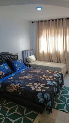 a bedroom with two beds and a window at Le Chaleureux 34 face de la gare CTM Hivernage in Marrakech