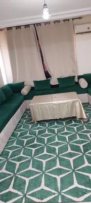 a room with a couch and a bed in a tent at Le Chaleureux 34 face de la gare CTM Hivernage in Marrakech