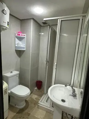 a bathroom with a toilet and a shower and a sink at Le Chaleureux 34 face de la gare CTM Hivernage in Marrakech
