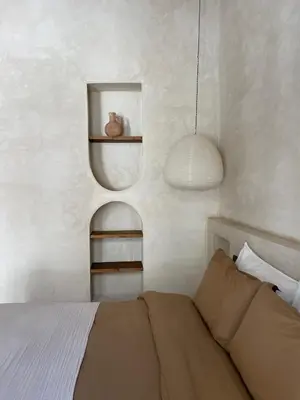 a bedroom with a bed and a lamp and a shelf at Riad Roca in Marrakech