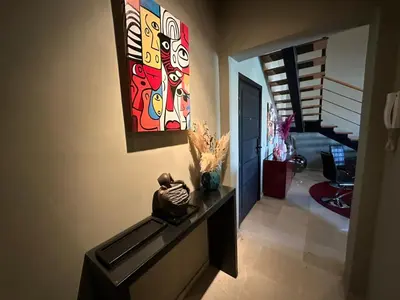 a hallway with a painting hanging on the wall at Duplex à l hivernage in Marrakech