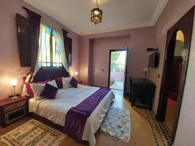 a bedroom with a large bed and a window at Jasmin d'Atlas in Marrakech