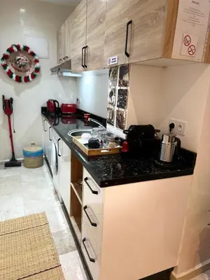 a kitchen with a sink and a counter top at le chaleureux a 10mn de l'aeroport face a la gare CTM Hivernage in Marrakech