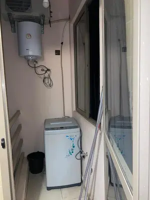 a small washing machine in a room with a window at Appartement au Cœur de Guéliz in Marrakech