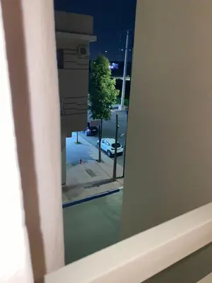a window with a view of a street at night at Appartement au Cœur de Guéliz in Marrakech