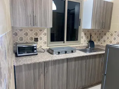 a kitchen with a counter with a microwave and a sink at Appartement au Cœur de Guéliz in Marrakech