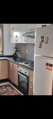 a kitchen with a white refrigerator and a stove at Prestigia réve in Marrakech