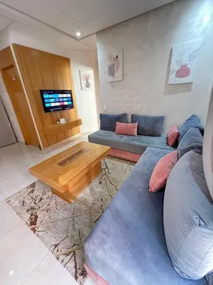 a living room with a couch and a table at Calm apartment 10 min from Majorelle Garden in Marrakech