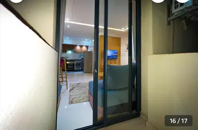 a view of a living room and a kitchen through a glass door at Calm apartment 10 min from Majorelle Garden in Marrakech