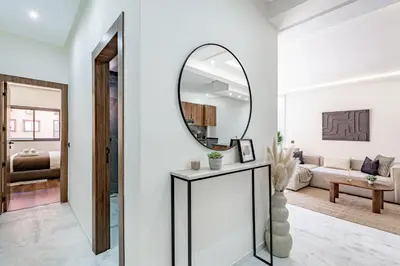 a living room with a mirror and a couch at Serenite tranquille au coeur du centre ville in Marrakech
