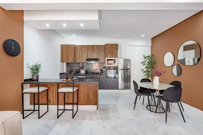 a kitchen and dining room with a table and chairs at Serenite tranquille au coeur du centre ville in Marrakech