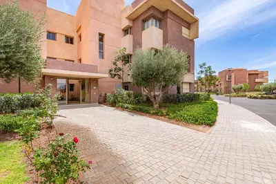 a building with a brick walkway in front of it at Luxury Garden-Level Apartment with Poolside Serenity in Marrakech
