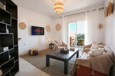 a living room with a couch and a coffee table at Le Joyau De Majorelle - Marrakech in Marrakech