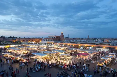 a crowd of people walking around a market at night at Le Joyau De Majorelle - Marrakech in Marrakech