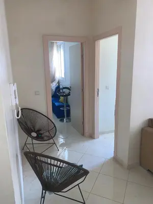 a living room with two chairs and a hallway at المنتزه الجديد in Marrakech