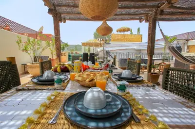 a table with plates of food on a patio at Riad Tampacao in Marrakech
