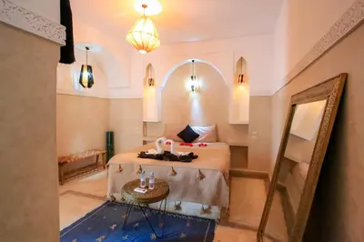 a hotel room with a bed and a mirror at Riad Tampacao in Marrakech