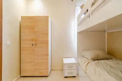 a small bedroom with a bunk bed and a closet at luxury appartement near gueliz voyageurs in Marrakech