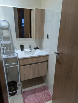 a bathroom with a sink and a mirror and a ladder at luxury appartement near gueliz voyageurs in Marrakech