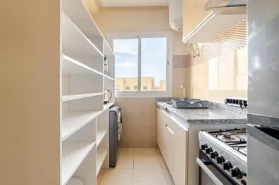 a kitchen with white cabinets and a window at luxury appartement near gueliz voyageurs in Marrakech