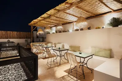 a restaurant with tables and chairs in a room at Riad Dar Acsameda & Spa in Marrakech