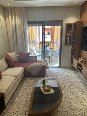 a living room with a couch and a coffee table at Luxury Apartment in Central Marrakech - Pool & Fast Wi-Fi in Marrakech