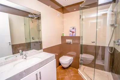 a bathroom with a toilet and a sink and a shower at vue imprenable sur les jardins de la villa d Yves saint Laurent in Marrakech