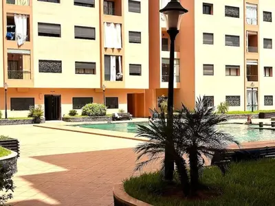 a building with a swimming pool in front of a building at Ali in Marrakech