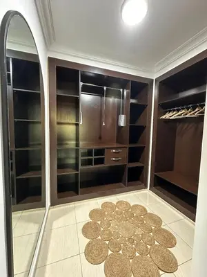 a walk in closet with a large mirror and a rug at Apartment Gueliz Victor Hugo in Marrakech