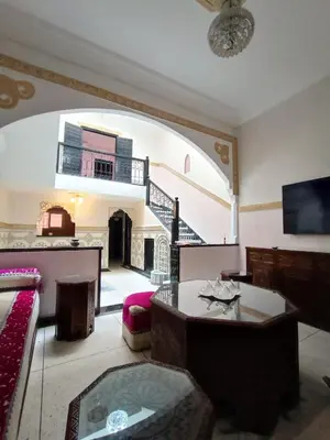 a large living room with an archway and a table at MARRAKECh TYPICAL HOUSE MAISON TYPIQUE MARRAKECH G2 40 in Marrakech