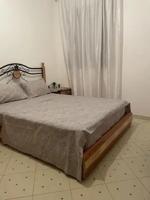 a bed sitting in a bedroom with a window at Jolie appartement à Marrakech in Marrakech