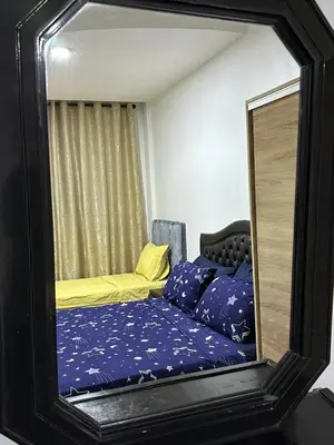 a mirror reflection of a bed in a room at DARNA 34 FACE GARE CTM HIVERNAGE a 10MN DE L'AEROPORT in Marrakech