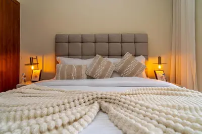 a large white bed with a large white blanket at Prestigia agate vue sur golf in Marrakech