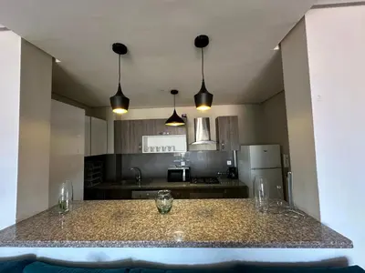 a kitchen with a counter with glasses on it at Appartement 2 chambres Atr67 Hivernage in Marrakech