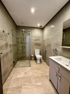 a bathroom with a shower and a toilet and a sink at Appartement 2 chambres Atr67 Hivernage in Marrakech