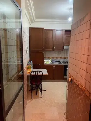 a small kitchen with a table and a chair at Heart of Marrakech in Marrakech
