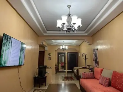 a living room with a couch and a chandelier at Heart of Marrakech in Marrakech