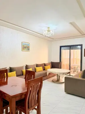 a living room with a couch and a table at Studio De luxe Avec BALCON in Marrakech