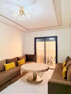 a living room with a couch and a table at Studio De luxe Avec BALCON in Marrakech